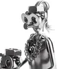 A close-up of a metal figurine made from nuts and bolts, depicting a caregiver with a wheelchair user. Voir les images du produit