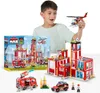 A boy is playing with a toy fire station set, holding a toy helicopter. Anteprima dell’immagine prodotto