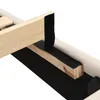 A close-up view of the wooden frame and black velcro strips of a bed. Podgląd zdjęcia produktu