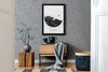 A stylish interior scene with a framed artwork, a wooden cabinet, a woven basket, and decorative items. Produktbild-Vorschau