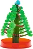 A small, artificial Christmas tree decorated with red beads and a blue pom-pom on top, sitting in a red plastic base. Produktbild-Vorschau