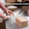 Hands cutting bubble wrap to pack a box. Produktbild-Vorschau