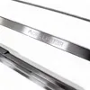 Close-up of metal skewers with a logo etched on one of them. Produktbild-Vorschau