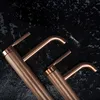 Two copper faucets are displayed on a dark, textured surface. Náhľad obrázku produktu