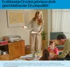 A family is gathered around a table, with a woman holding printed papers and a printer visible in the background. Voir les images du produit