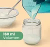Milk is being poured from a measuring jug into a glass jar. A bowl of yogurt is also visible. Produktbild-Vorschau