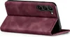 A burgundy flip cover case for a smartphone is shown in a studio setting. Produktbild-Vorschau