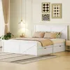 A white wooden bed with drawers in a bedroom setting. Produktbild-Vorschau