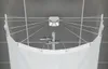 A white shower screen with multiple arms is attached to the ceiling, holding up a white shower curtain. A shower head is visible in the background. Produktbild-Vorschau