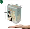 A tin box with a vintage movie poster design, featuring Audrey Hepburn, is shown with dimensions indicated. A hand is placed below the box. Podgląd zdjęcia produktu