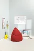 A child's room with a red beanbag chair, a world map on the wall, and a bookshelf. Náhled obrázku produktu