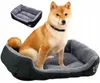 A dog is sitting in a dog bed, with another dog bed shown in the background. Anteprima dell’immagine prodotto