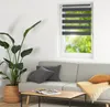 A living room scene with a sofa, coffee table, plant, and a window with blinds. Náhled obrázku produktu