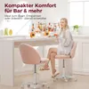 A woman sits at a bar counter, holding a drink, with two pink bar stools in the foreground. Produktbild-Vorschau