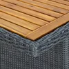 Close-up of the corner of a table, showing the wooden top and the woven rattan base. Anteprima dell’immagine prodotto
