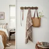 A hallway or entryway with a coat rack mounted on the wall. Produktbild-Vorschau
