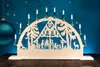 A wooden Christmas arch with candle lights and a scene of people and a deer. Produktbild-Vorschau