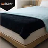 A close-up view of a bed with a navy blue quilted electric blanket and a light blue sheet. Náhľad obrázku produktu