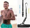 A young man on a beach holding a surfboard and a waterproof phone case on a lanyard, with product detail shots of the lanyard. Podgląd zdjęcia produktu