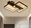 A modern black geometric ceiling light fixture with integrated LED lighting is shown mounted on a white ceiling. Produktbild-Vorschau