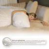 A woman sleeping on a bed with a large white pillow and duvet. Produktbild-Vorschau
