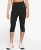 A woman wearing black Nike capri leggings and white athletic shoes. Produktbild-Vorschau