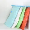 Four vacuum-sealed storage bags in different colors are arranged diagonally in a corner. Voir les images du produit