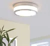 A modern ceiling light fixture with a chrome ring and frosted glass diffuser, mounted on a white ceiling. A green plant is visible in the foreground. Produktbild-Vorschau