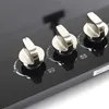A close-up shot of three control knobs on a black gas stove top. Náhled obrázku produktu