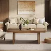 A living room scene with a sofa, coffee table, and artwork. Anteprima dell’immagine prodotto
