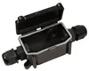 A black electrical junction box with its lid open, showing the interior and cable glands on either side. Produktbild-Vorschau