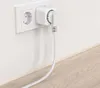 A white smart plug is plugged into a white wall socket, with a white cable extending downwards. Anteprima dell’immagine prodotto