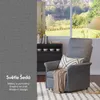 A gray armchair with a blanket and cushion is placed next to a window with a view of a garden. Text overlays describe the color and features of the armchair. Náhled obrázku produktu