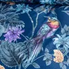 A close-up view of a patterned fabric with a bird and floral motifs. Náhled obrázku produktu