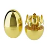 A gold egg-shaped cutlery set holder with cutlery inside, and a separate closed egg-shaped holder. Produktbild-Vorschau