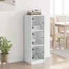 A white highboard with glass doors stands in a room, next to a dining table and chairs. Produktbild-Vorschau
