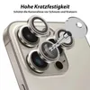 A close-up of a smartphone camera lens array with protective lens covers and a key. Produktbild-Vorschau