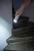 A hand holding a flashlight illuminates a set of stairs. Produktbild-Vorschau