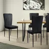 A dining room setting with a wooden table and black chairs. Náhled obrázku produktu
