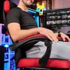 A man is sitting in a gaming chair in front of a computer. Produktbild-Vorschau