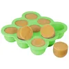 A green silicone mold filled with tan-colored baby food portions, with one portion removed and placed next to the mold. Produktbild-Vorschau