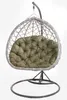 A hanging egg chair with a green cushion, shown against a white background. Voir les images du produit