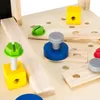 A close-up view of a wooden toy workbench with various colorful toy tools and fasteners. Anteprima dell’immagine prodotto