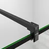 Close-up of a black metal frame attached to a green glass panel, likely part of a shower enclosure. Produktbild-Vorschau