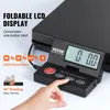 A close-up of a black digital scale with a foldable LCD display and a hand pressing a button. Náhled obrázku produktu