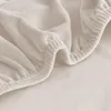 A close-up view of a beige velour fabric with elastic edging. Anteprima dell’immagine prodotto