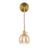 A single vintage-style wall lamp with a fluted glass shade and a brass finish. Podgląd zdjęcia produktu