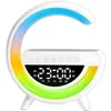 A white bedside lamp with a curved LED light that displays a rainbow gradient. The lamp has a digital clock display showing 23:00 and several control buttons. Podgląd zdjęcia produktu