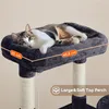A cat is resting on a dark gray cat tree perch, with dimensions indicated by orange labels. Produktbild-Vorschau
