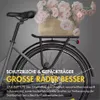 Close-up of the rear wheel and basket of a bicycle, with text overlays highlighting features. Produktbild-Vorschau